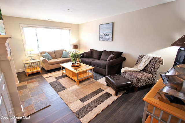 living room with a fireplace, wood finished floors, and baseboards