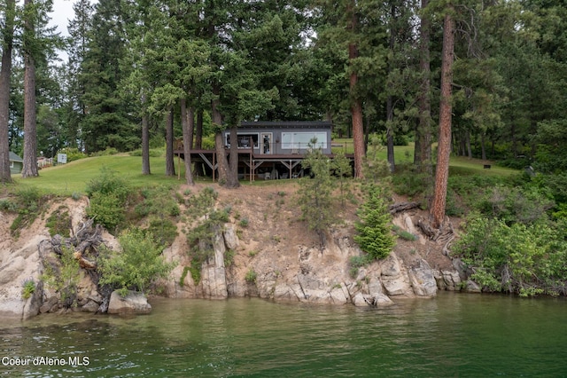 rear view of property featuring a deck with water view