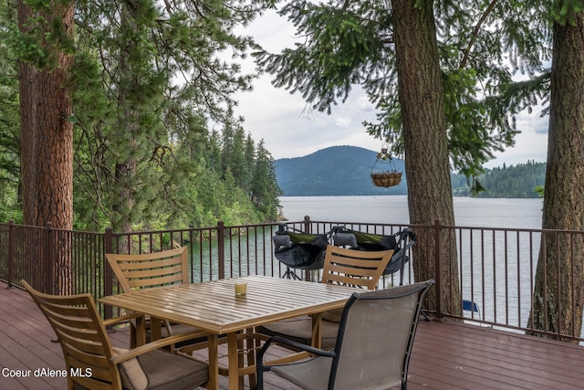 wooden terrace with a water and mountain view