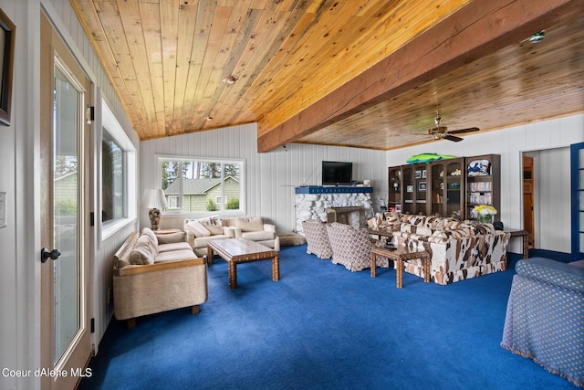 living room featuring carpet floors, vaulted ceiling with beams, ceiling fan, a fireplace, and wood ceiling