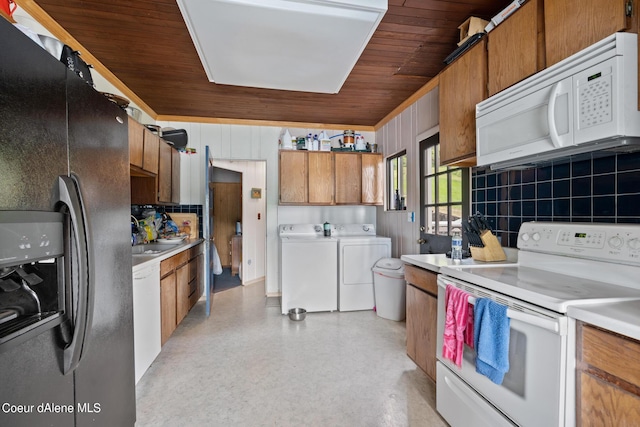 kitchen with white appliances, tasteful backsplash, washer and clothes dryer, and wooden ceiling