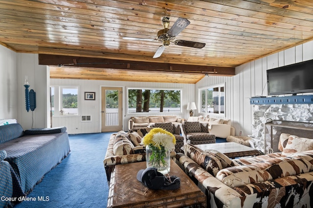 living room featuring wooden walls, wooden ceiling, carpet floors, and a wealth of natural light