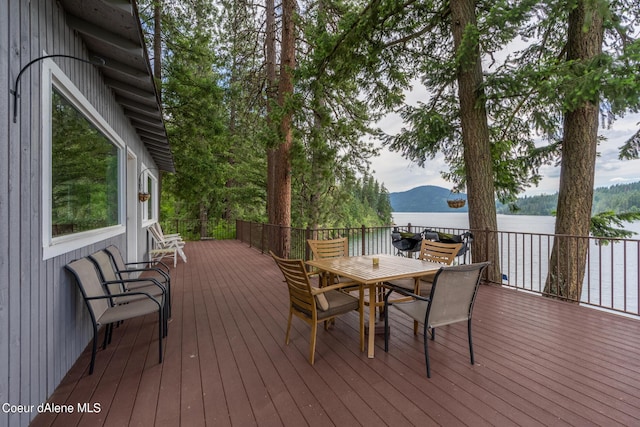 wooden deck featuring a water and mountain view