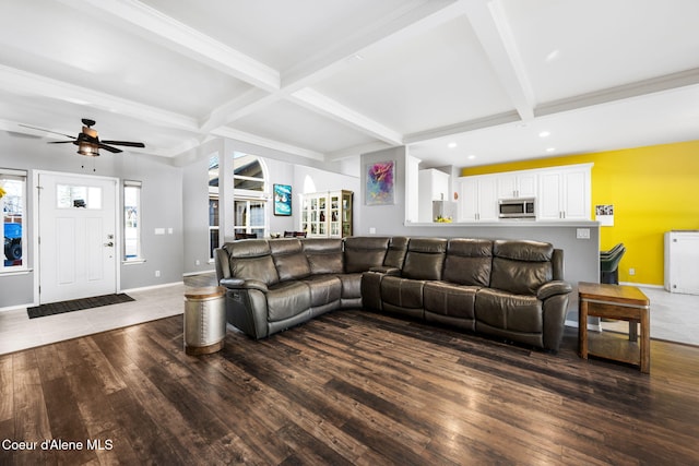 living room featuring beam ceiling, dark hardwood / wood-style floors, and ceiling fan