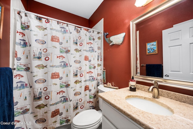 bathroom with vanity, curtained shower, and toilet