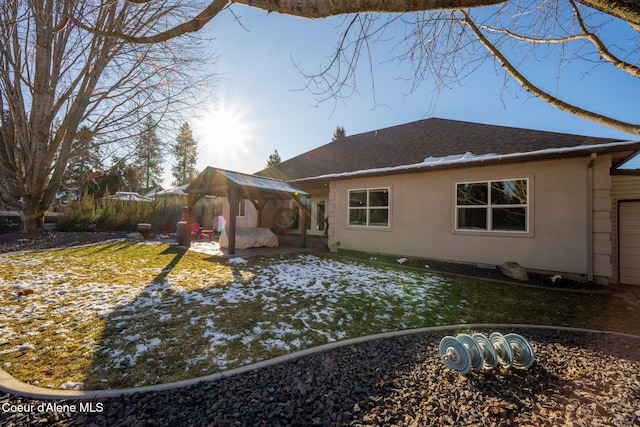 rear view of house featuring a gazebo and a lawn