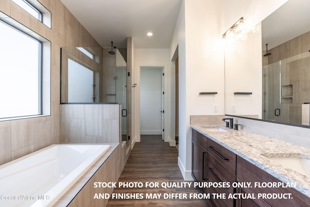 bathroom featuring separate shower and tub, a wealth of natural light, and hardwood / wood-style flooring