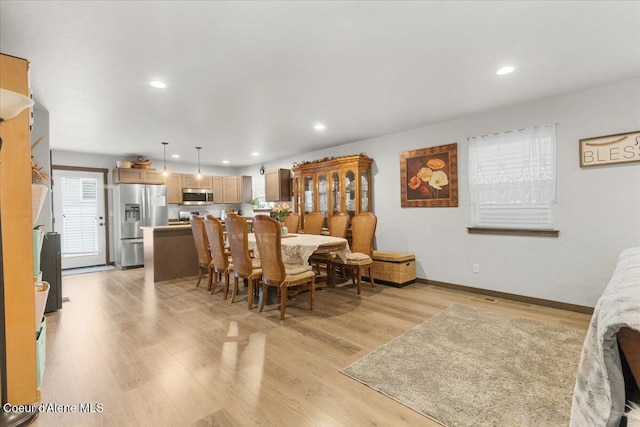 dining space with light wood-type flooring