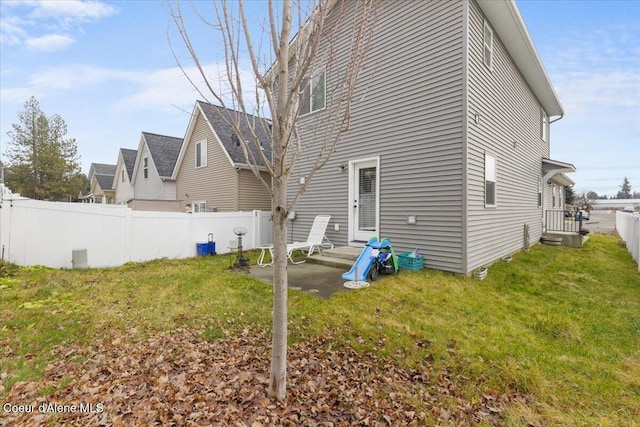 rear view of house featuring a lawn