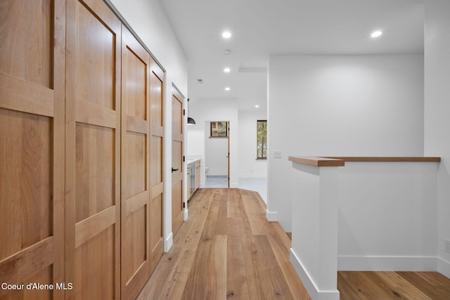 corridor with light wood-type flooring