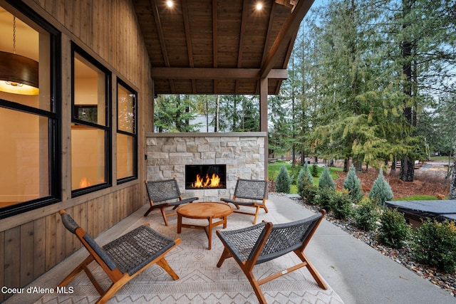 view of patio / terrace featuring an outdoor stone fireplace