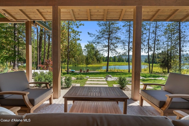 sunroom / solarium featuring a water view