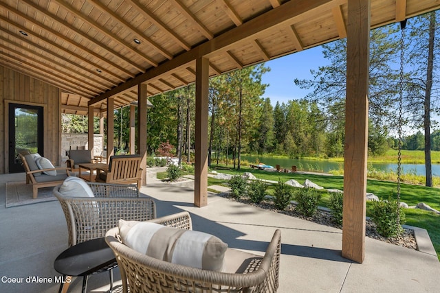 view of patio with outdoor lounge area and a water view