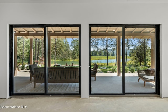 entryway with concrete flooring and a water view