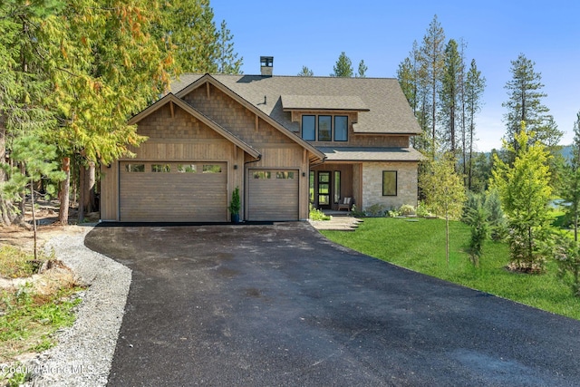 view of front of property featuring a front yard and a garage