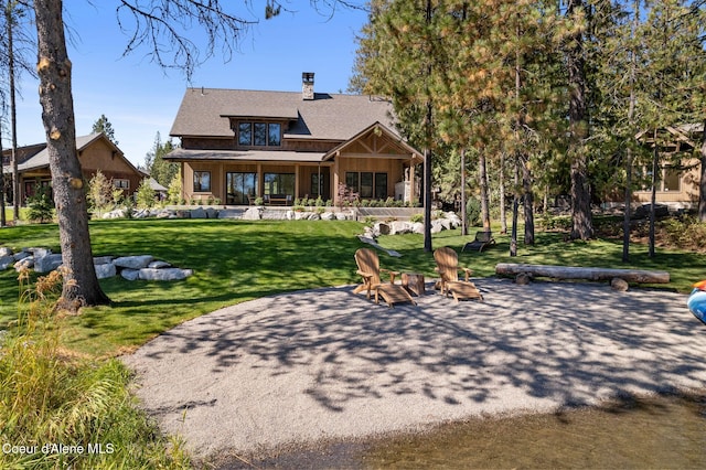 back of property featuring a lawn and a patio area