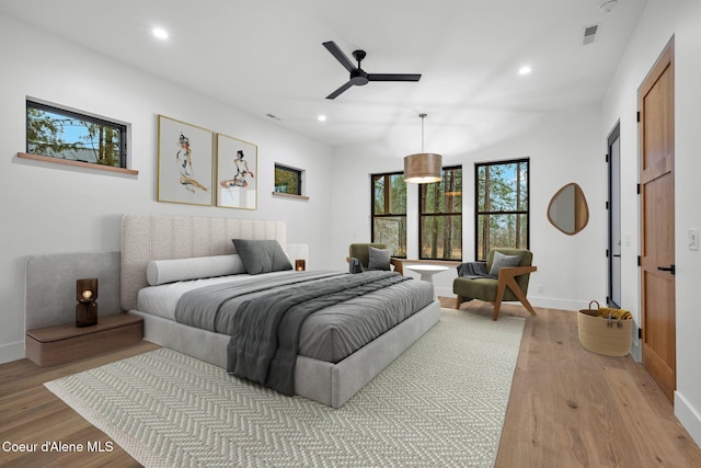 bedroom with ceiling fan and light hardwood / wood-style floors