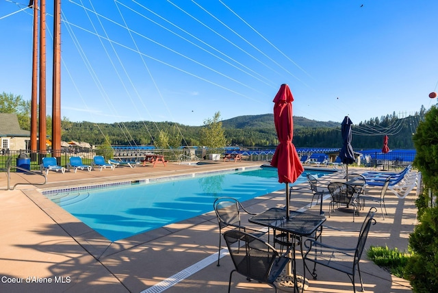 view of pool with a patio area and a mountain view