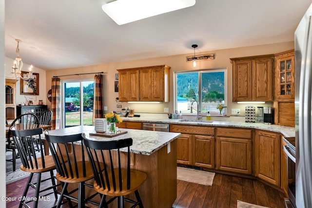 kitchen featuring a chandelier, sink, pendant lighting, and dark hardwood / wood-style floors