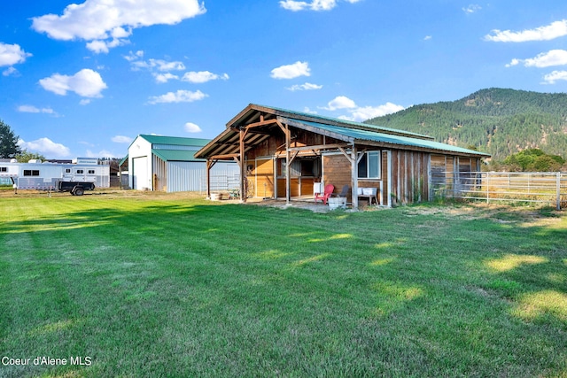 view of front facade featuring a mountain view and an outbuilding