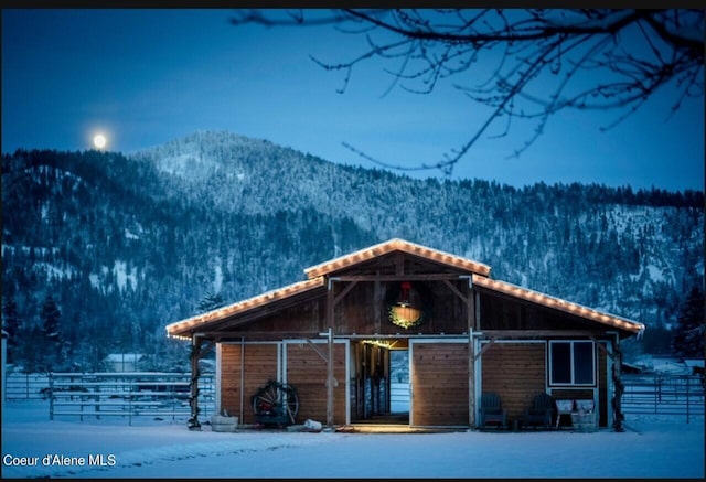 view of front of house featuring a mountain view and an outbuilding