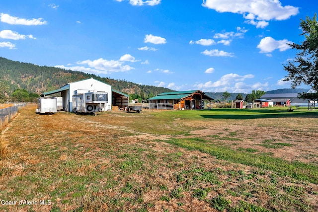 view of yard with a mountain view and an outdoor structure