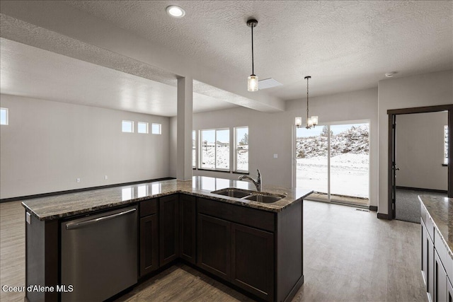 kitchen with dishwasher, sink, a chandelier, dark stone counters, and dark brown cabinets