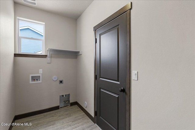 clothes washing area with hookup for an electric dryer, light hardwood / wood-style floors, and washer hookup