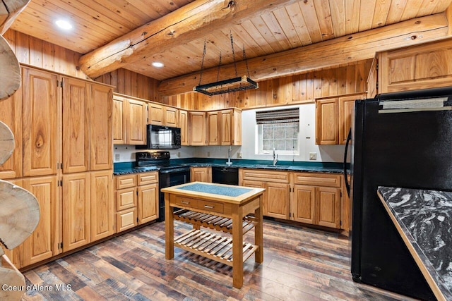 kitchen with dark hardwood / wood-style flooring, wooden walls, sink, black appliances, and beam ceiling