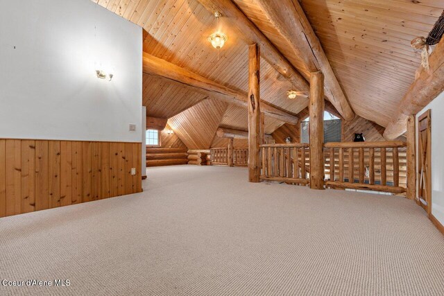 bonus room featuring carpet, lofted ceiling with beams, wood ceiling, and wooden walls