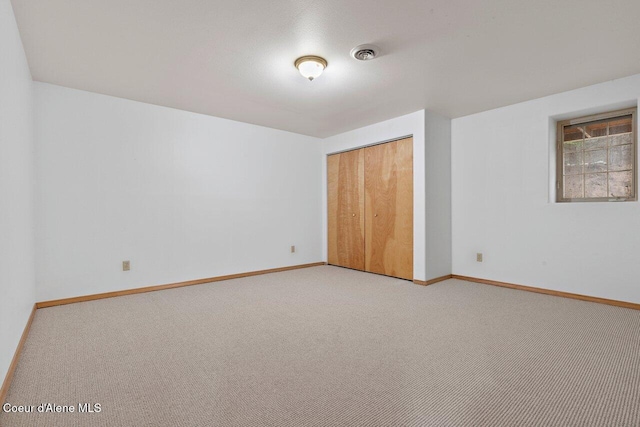 unfurnished bedroom featuring a closet and carpet