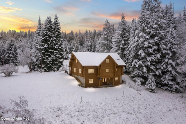 view of snow covered rear of property