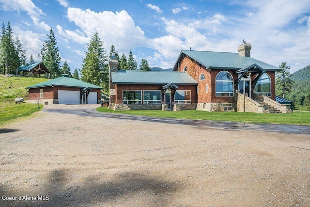 view of front facade featuring an outbuilding and a garage