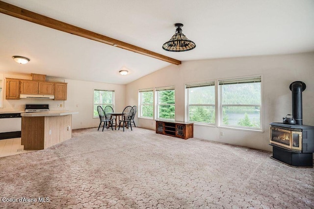 kitchen featuring pendant lighting, a wood stove, light carpet, ventilation hood, and range