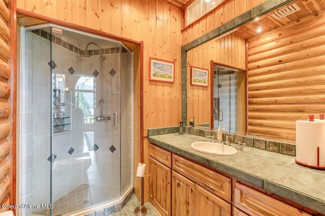 bathroom with vanity, an enclosed shower, rustic walls, and wooden walls