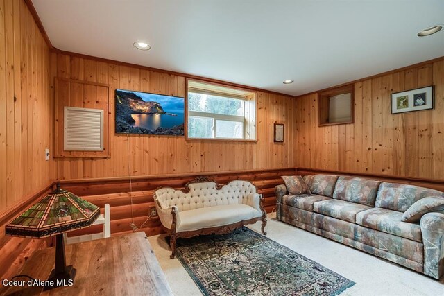 living room with carpet, rustic walls, and wooden walls