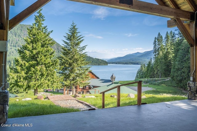 exterior space with a water and mountain view