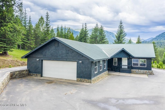 ranch-style home with a mountain view and a garage