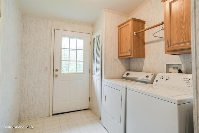 laundry room featuring washer and dryer, cabinets, and ornamental molding