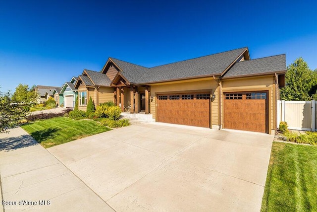 craftsman-style home with a garage and a front yard