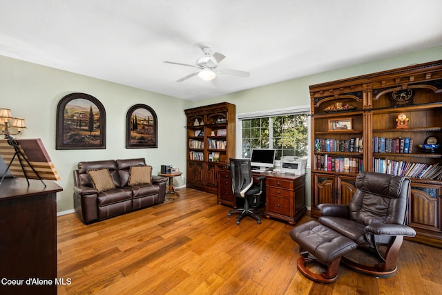 home office featuring light wood-type flooring and ceiling fan