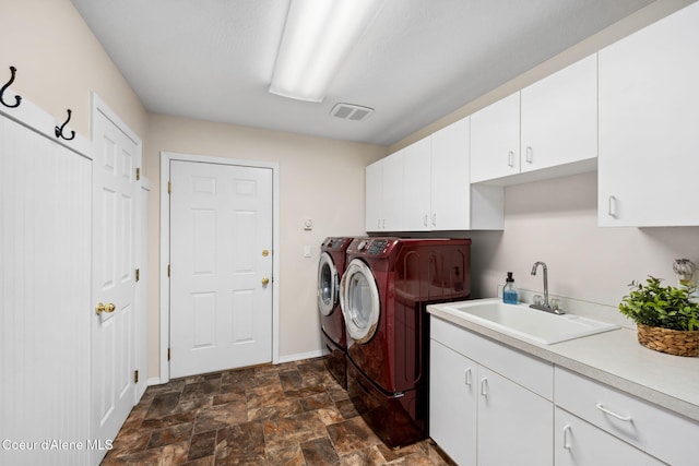 laundry room with washer and clothes dryer, sink, and cabinets