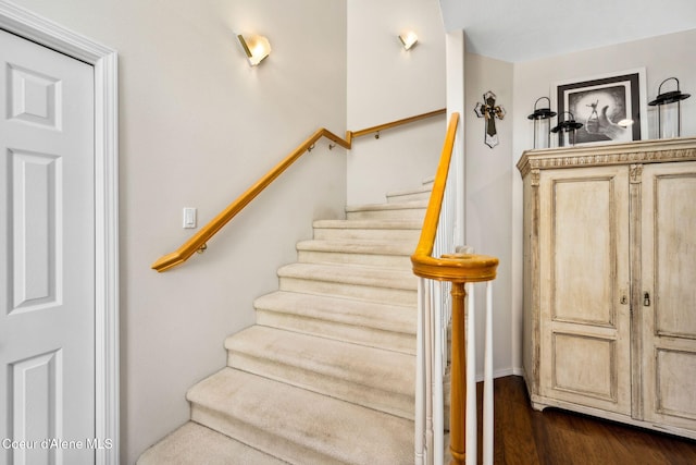 stairs featuring hardwood / wood-style flooring