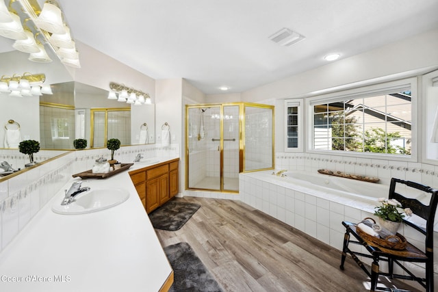 bathroom featuring wood-type flooring, vanity, and separate shower and tub