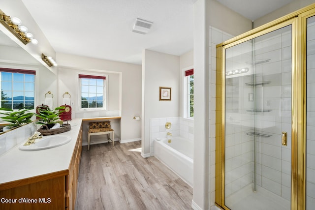 bathroom featuring vanity, shower with separate bathtub, and hardwood / wood-style flooring