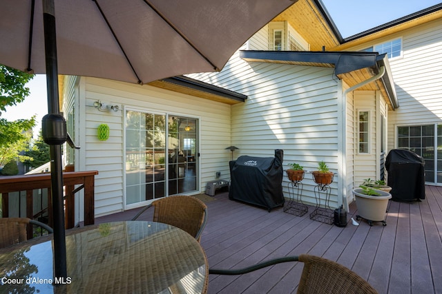 wooden deck featuring a grill