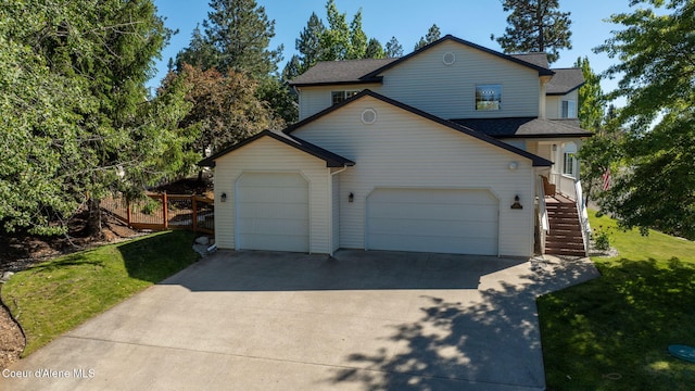 view of front property featuring a front lawn and a garage