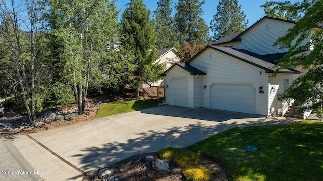 view of home's exterior with a yard and a garage