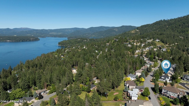 drone / aerial view featuring a water and mountain view