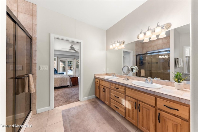 bathroom with connected bathroom, a sink, tile patterned floors, double vanity, and a stall shower